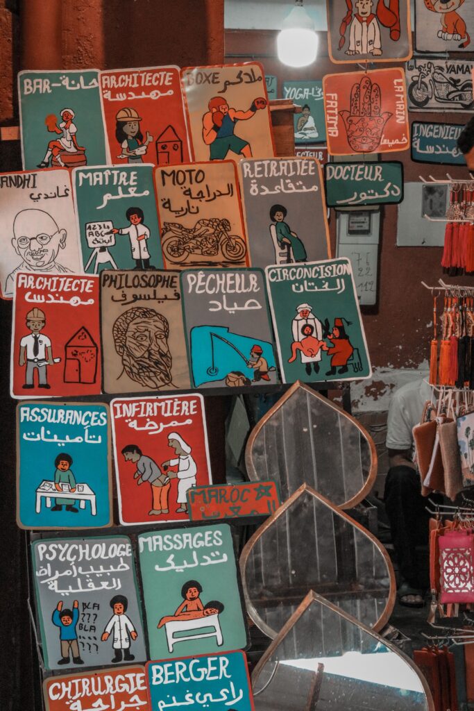 Vibrant display of handmade Moroccan signs in a market stall.