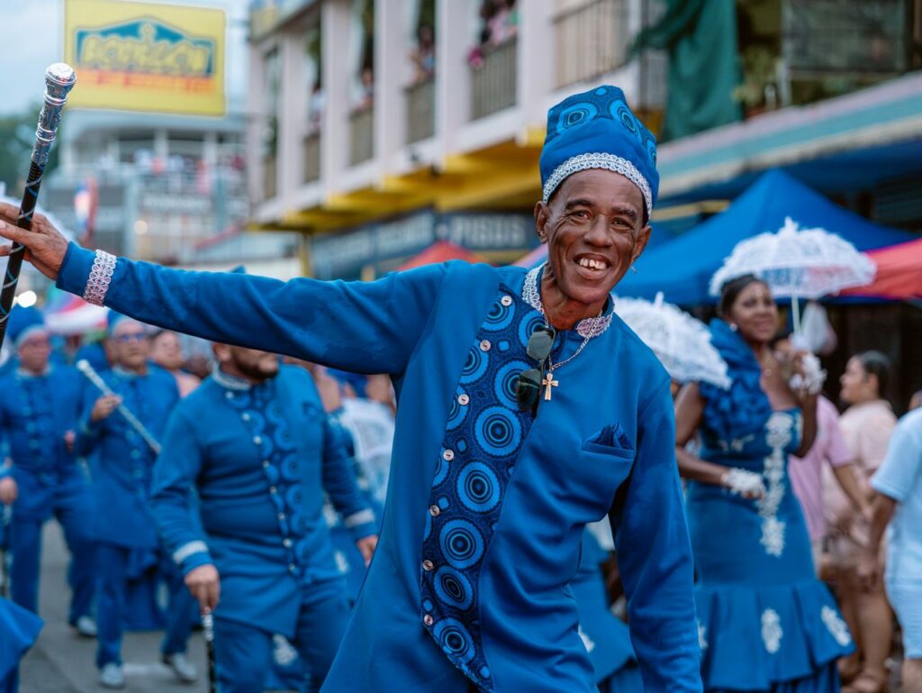 Colorful festival celebration in Limón, Costa Rica, featuring joyful participants in traditional attire.