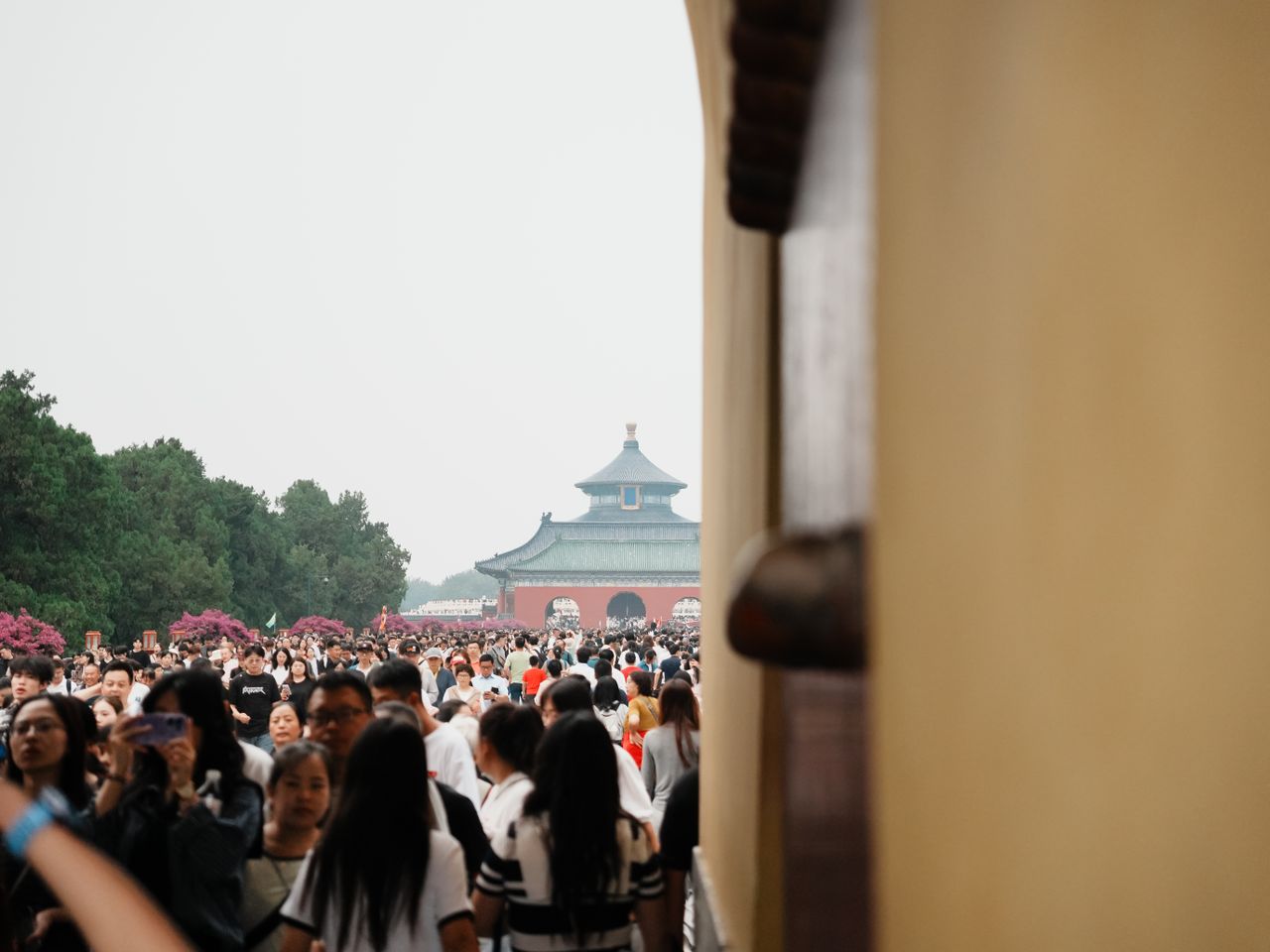 A bustling crowd at the iconic Temple of Heaven in Beijing, China.