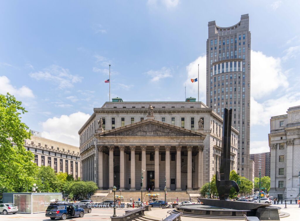 View of the historic New York County Courthouse with clear skies and cityscape.