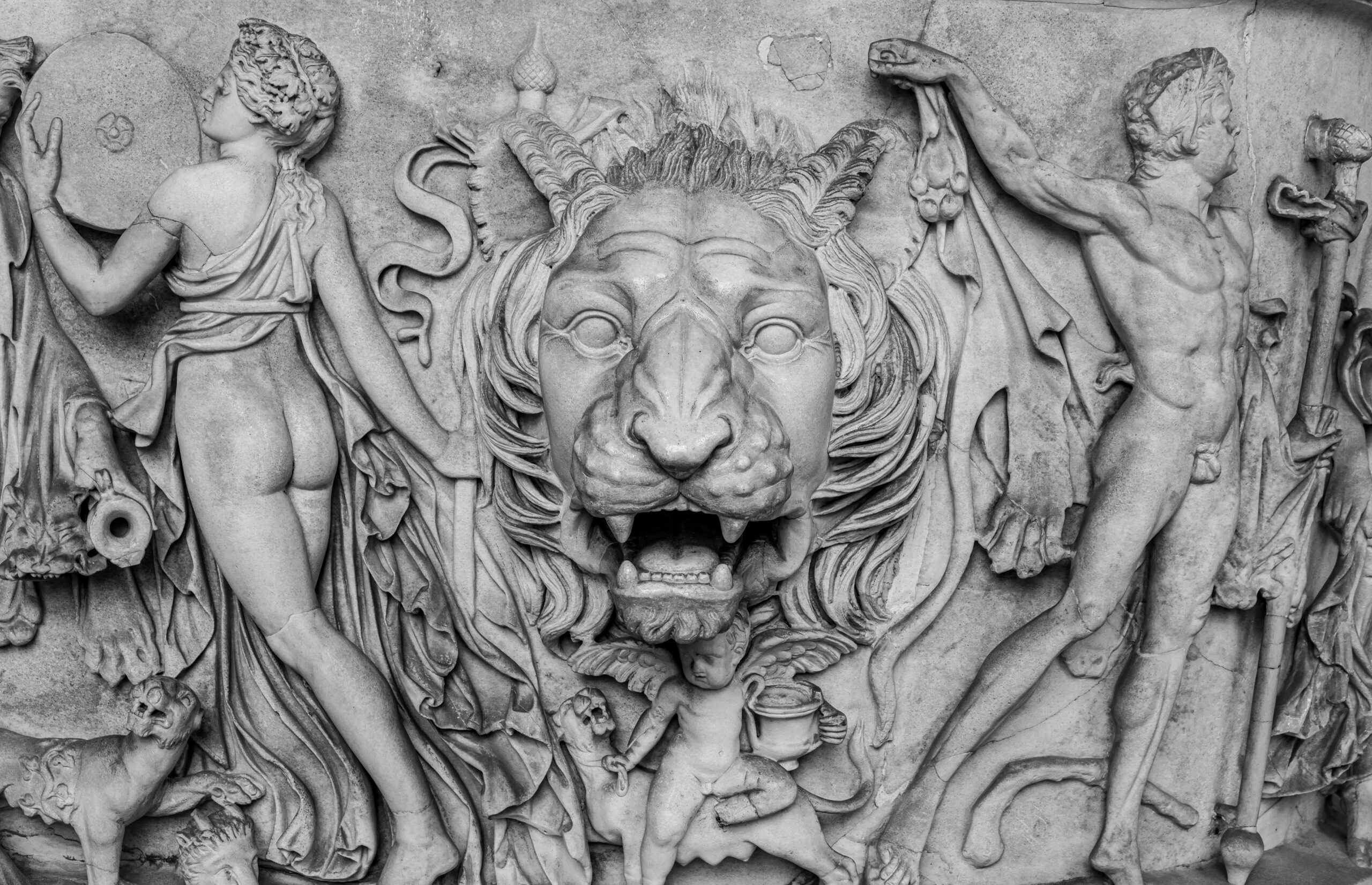 Detailed ancient Roman marble relief depicting mythological figures and a central lion motif.