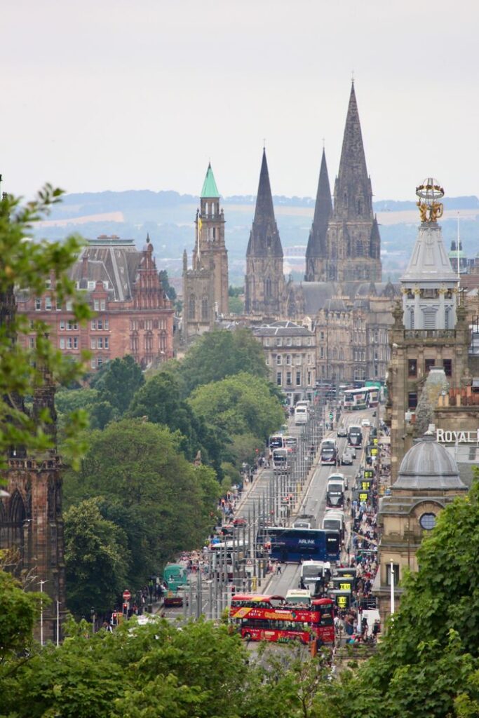 Explore the bustling cityscape of Edinburgh featuring iconic historic landmarks and busy streets.