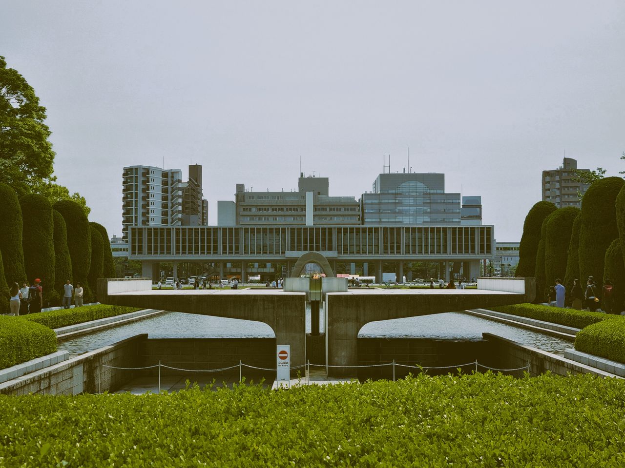 Exterior view of Hiroshima Peace Memorial Museum showcasing modern architecture and landscaped gardens.