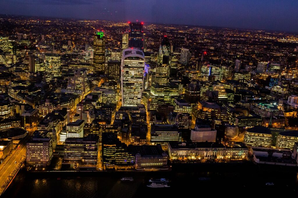 A stunning aerial view capturing London's illuminated skyline at night.