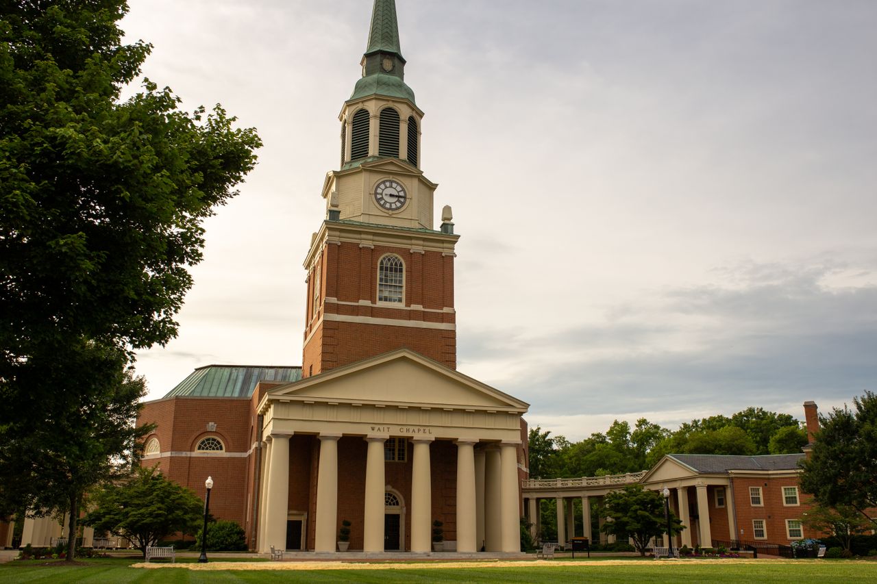 Stunning view of Wait Chapel on a summer day with lush greenery and overcast sky, perfect for travel and architecture themes.
