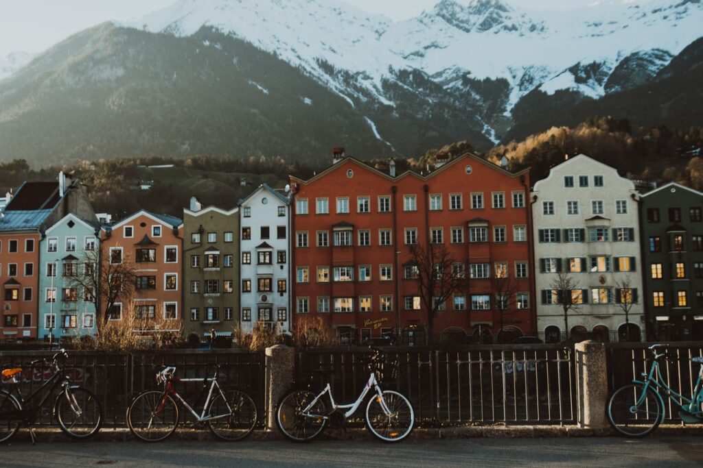 Picturesque scene of colorful facades in Innsbruck against snowy mountains.