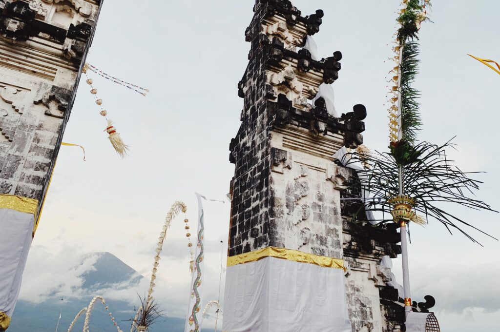 View of traditional Balinese temple gates with scenic Mount Agung in the distance.