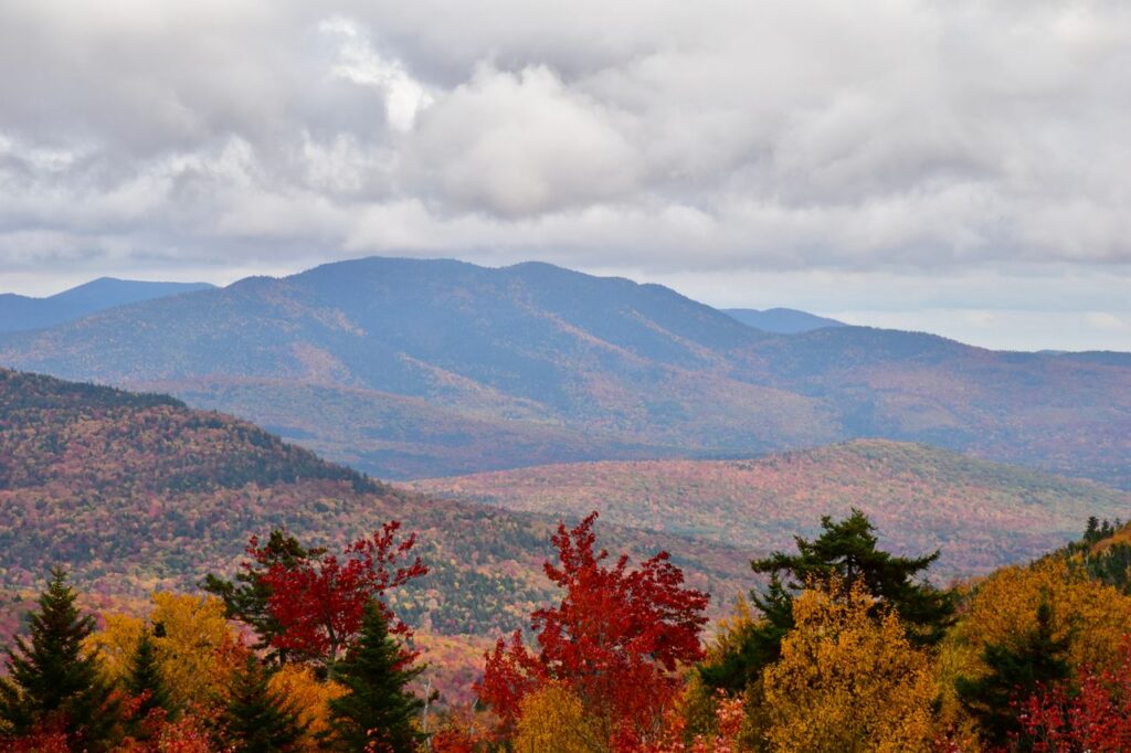 Stunning aerial view of fall foliage in the White Mountains, featuring vibrant colors and scenic landscapes.